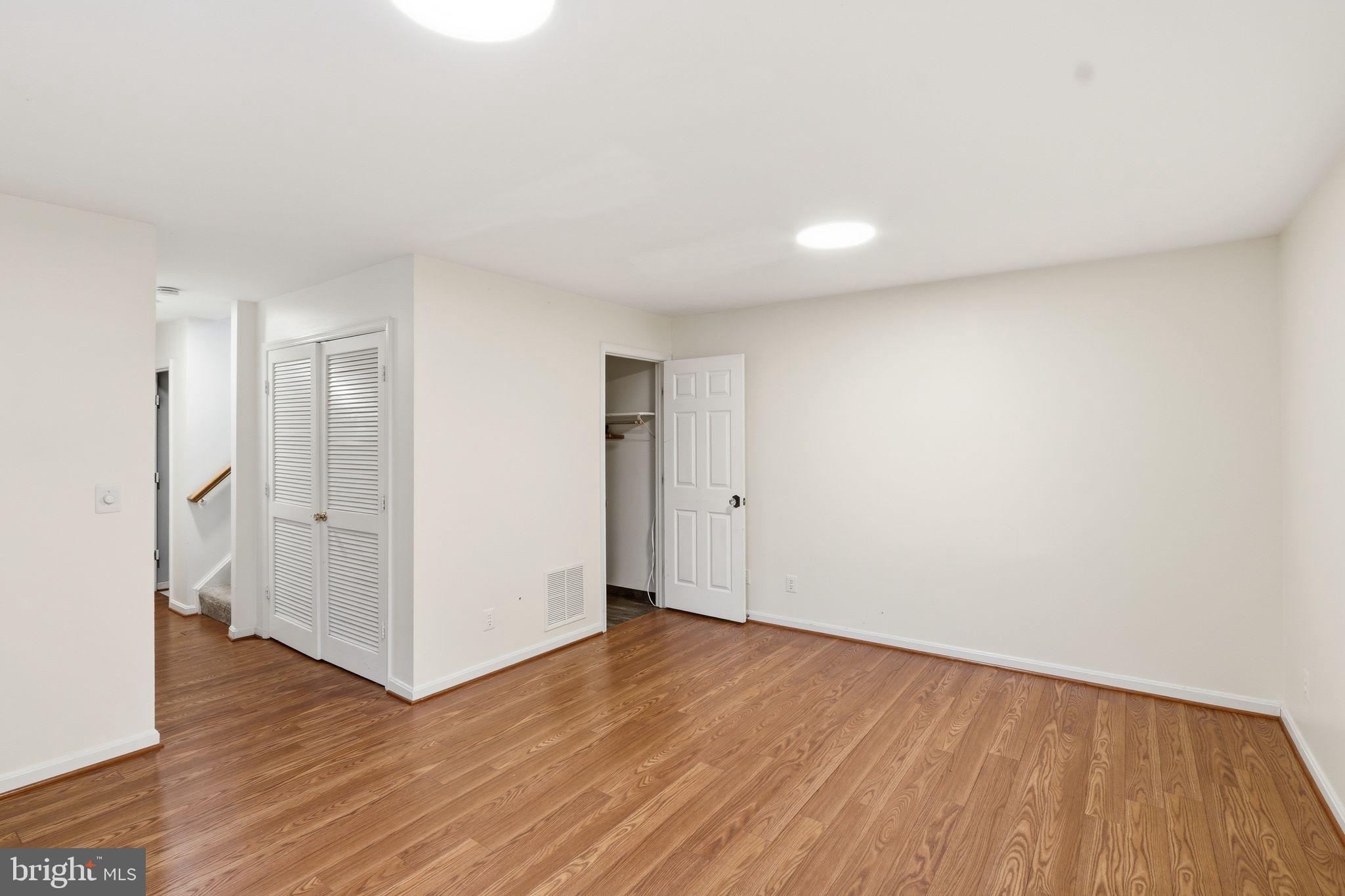 15663 Viewpoint Circle Dumfries, VA 22025 - Photo 18 of 30 a view of an empty room with wooden floor and a window