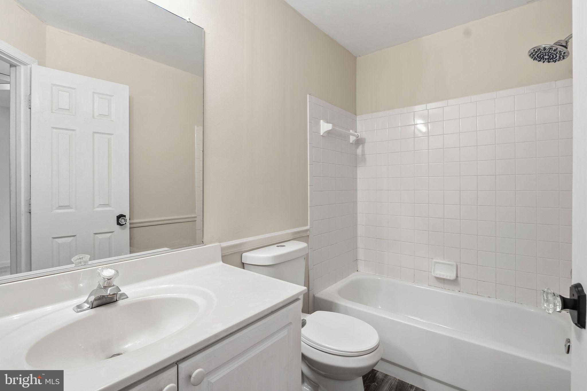 15663 Viewpoint Circle Dumfries, VA 22025 - Photo 20 of 30 a bathroom with a bathtub shower sink vanity mirror and toilet
