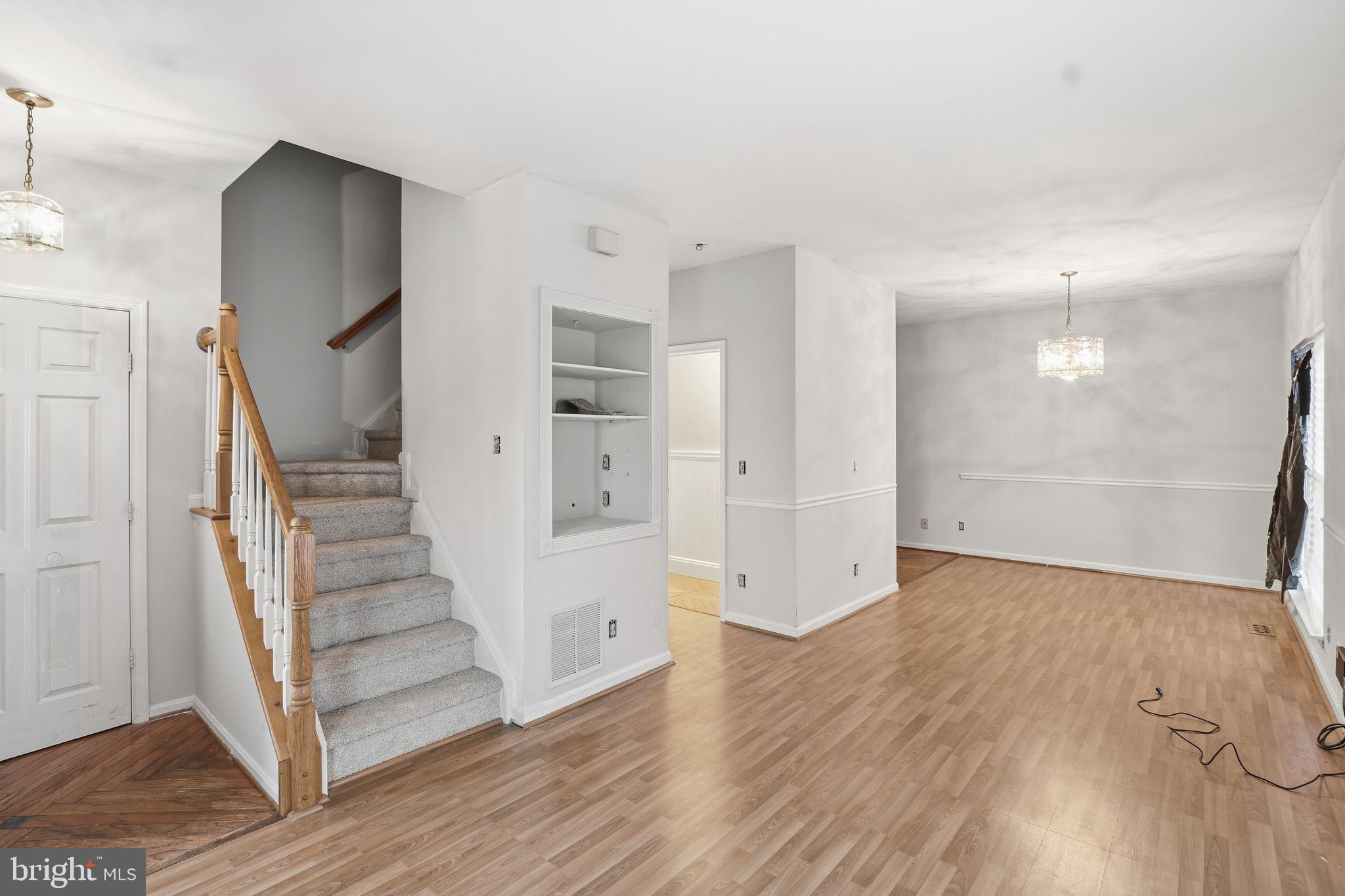15663 Viewpoint Circle Dumfries, VA 22025 - Photo 9 of 30 an empty room with wooden floor and staircase