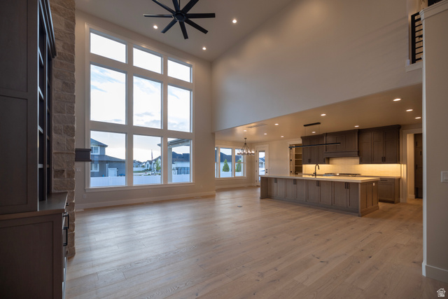 904 South 1900 West Layton, UT 84041 - Photo 7 of 19 Unfurnished living room with hanging lights, and a high ceiling