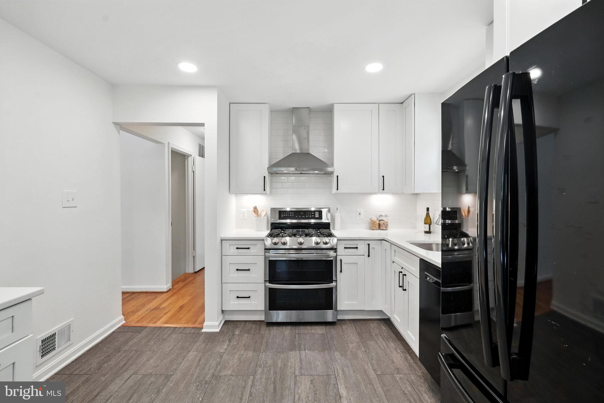 6910 Barnack Drive Springfield, VA 22152 - Photo 12 of 44 a kitchen with stainless steel appliances a stove and a refrigerator