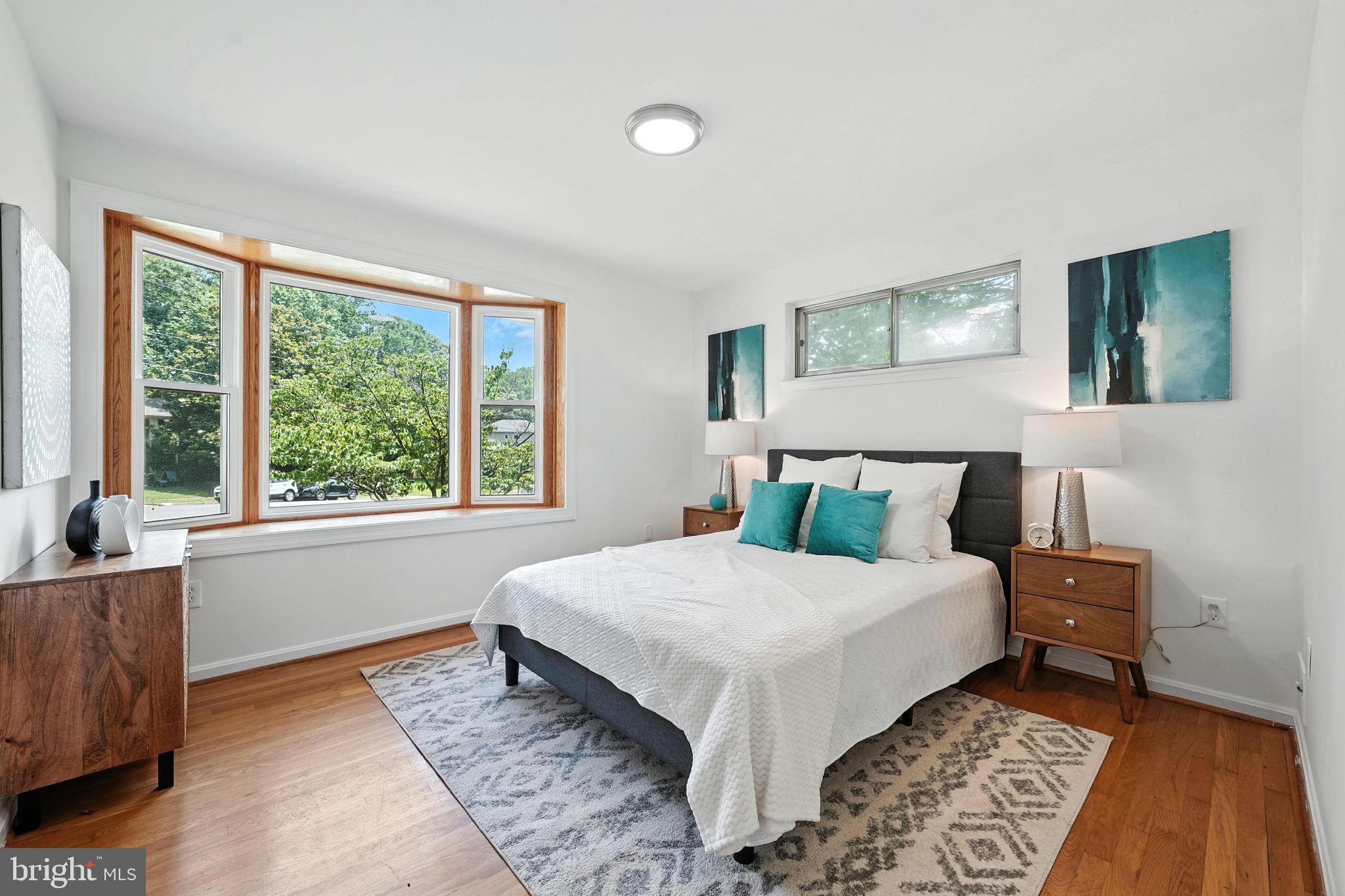 6910 Barnack Drive Springfield, VA 22152 - Photo 14 of 44 a bedroom with a large bed and a window