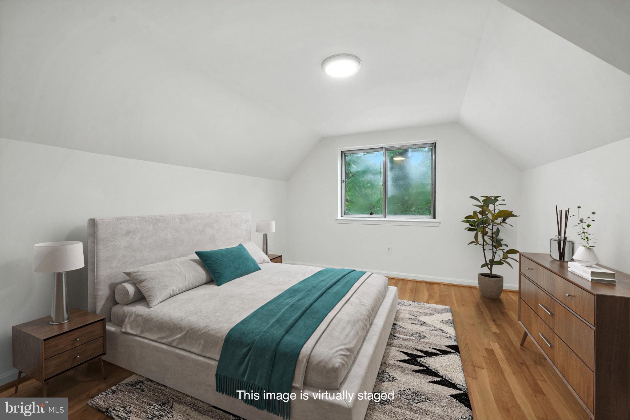 6910 Barnack Drive Springfield, VA 22152 - Photo 21 of 44 a bedroom with a bed and a potted plant