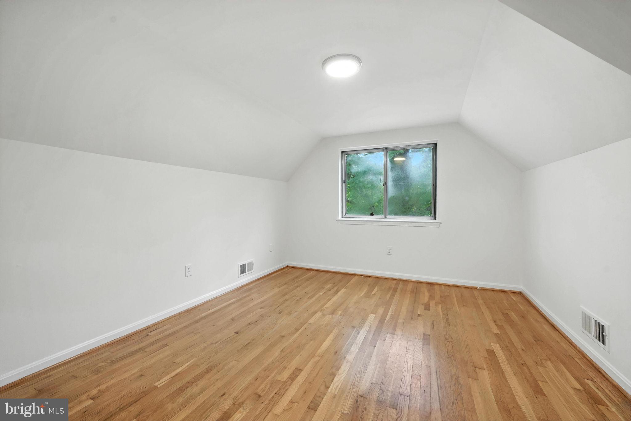 6910 Barnack Drive Springfield, VA 22152 - Photo 22 of 44 an empty room with wooden floor and windows
