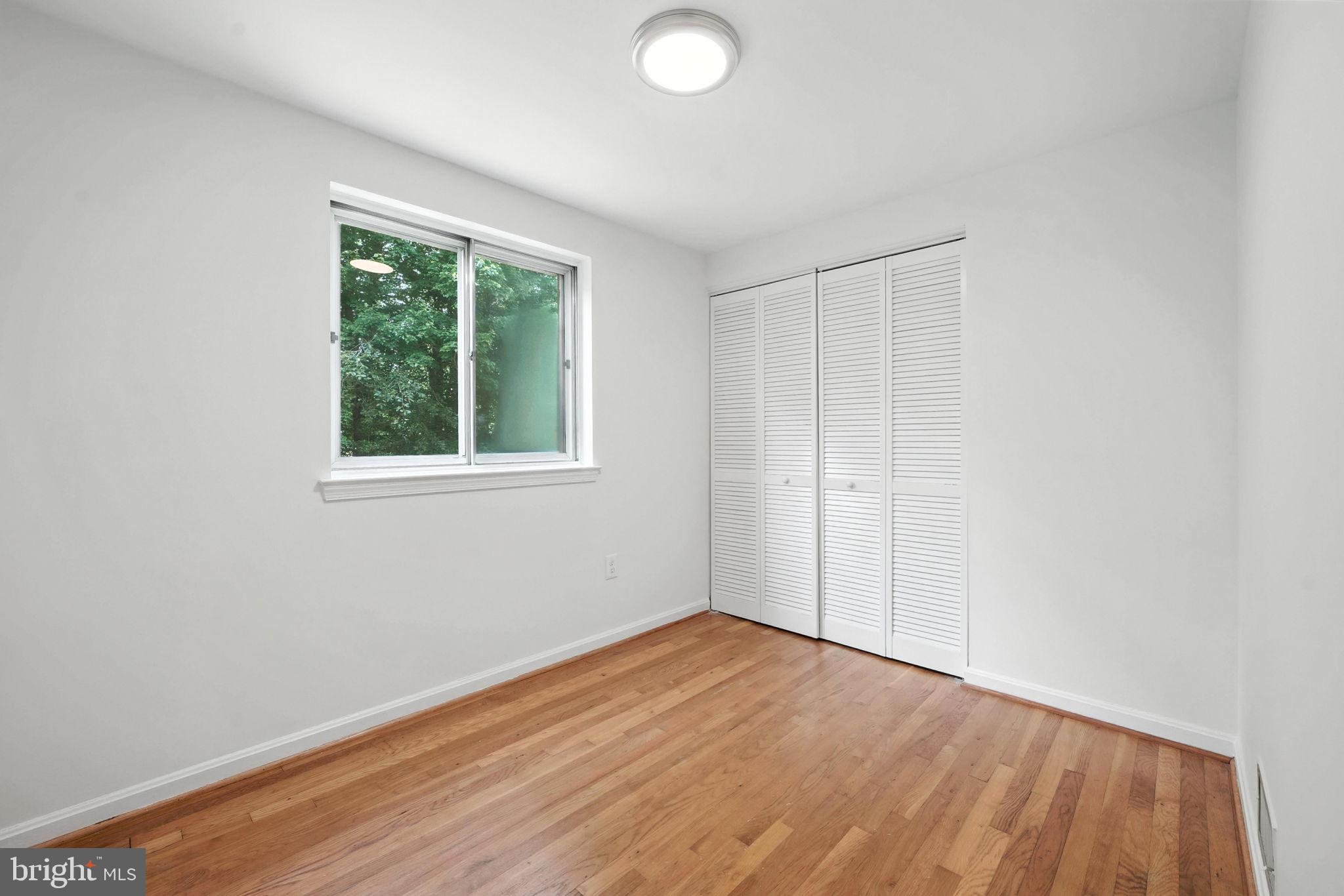 6910 Barnack Drive Springfield, VA 22152 - Photo 25 of 44 an empty room with wooden floor and windows
