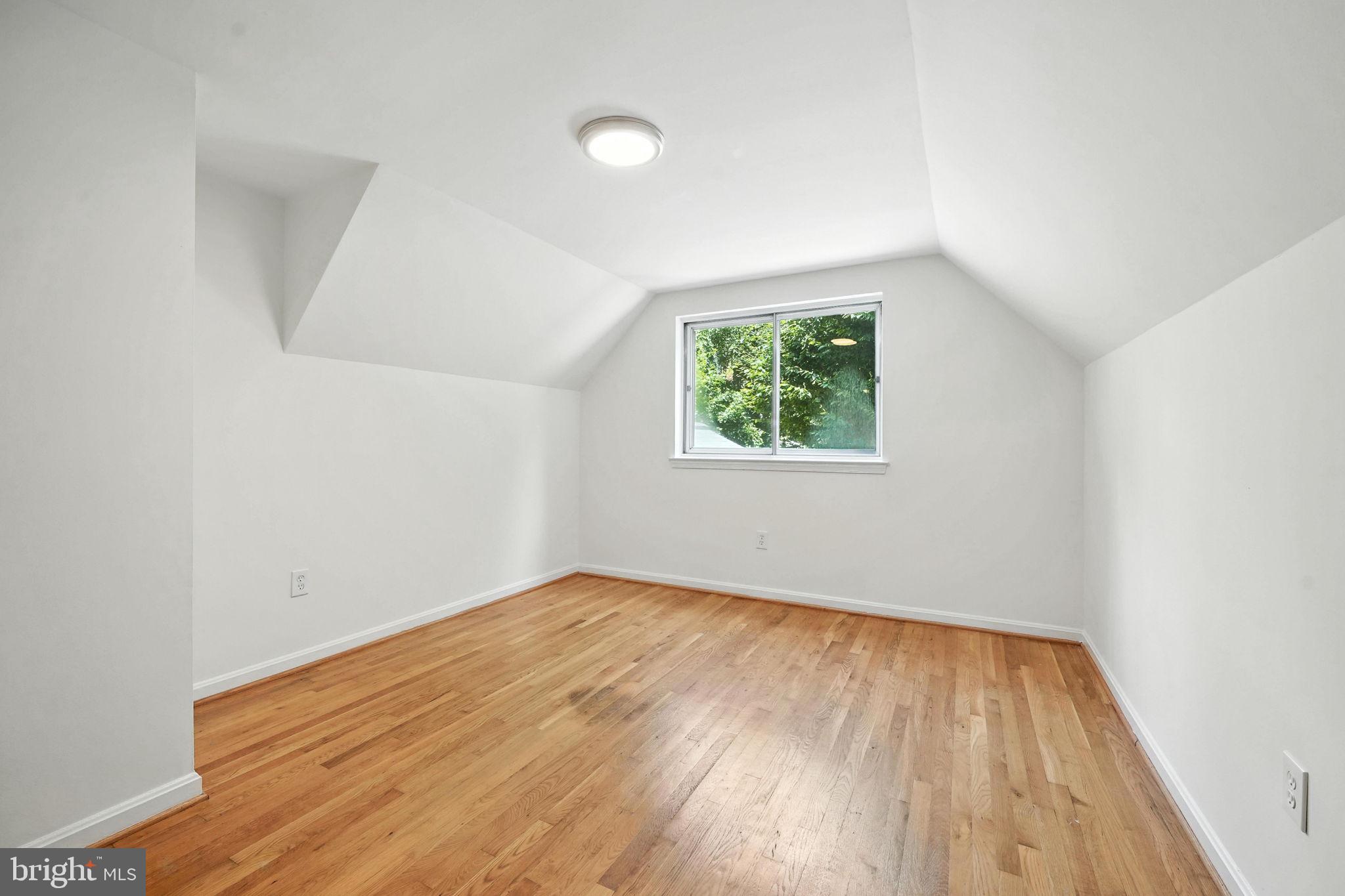 6910 Barnack Drive Springfield, VA 22152 - Photo 26 of 44 an empty room with wooden floor and windows