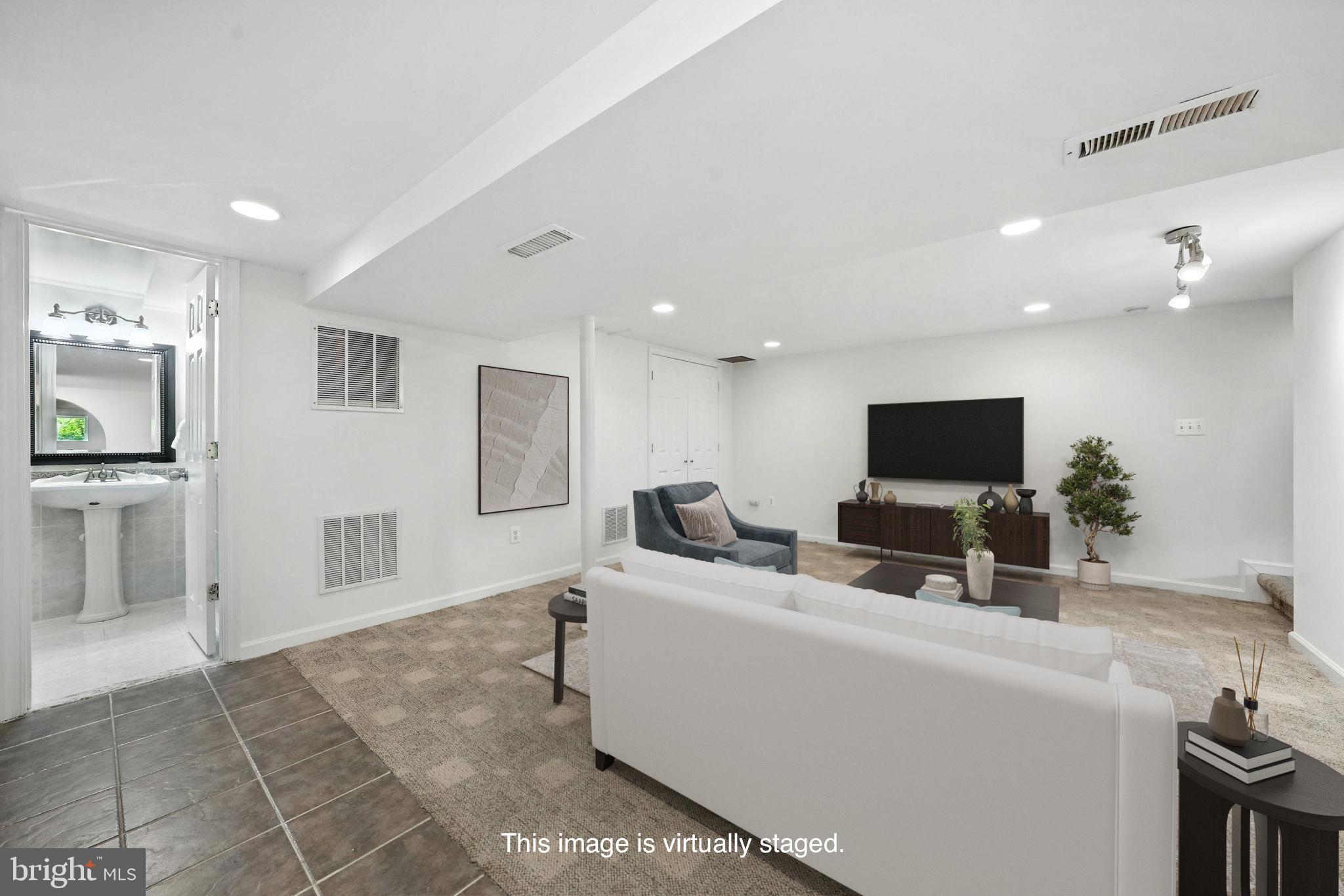 6910 Barnack Drive Springfield, VA 22152 - Photo 33 of 44 a living room with furniture and a flat screen tv