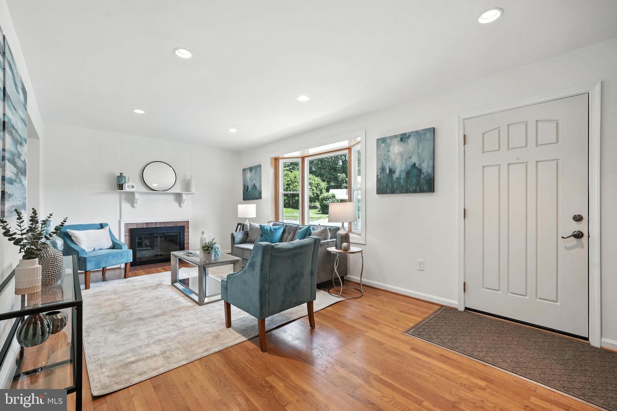 6910 Barnack Drive Springfield, VA 22152 - Photo 6 of 44 a living room with furniture a fireplace and a window