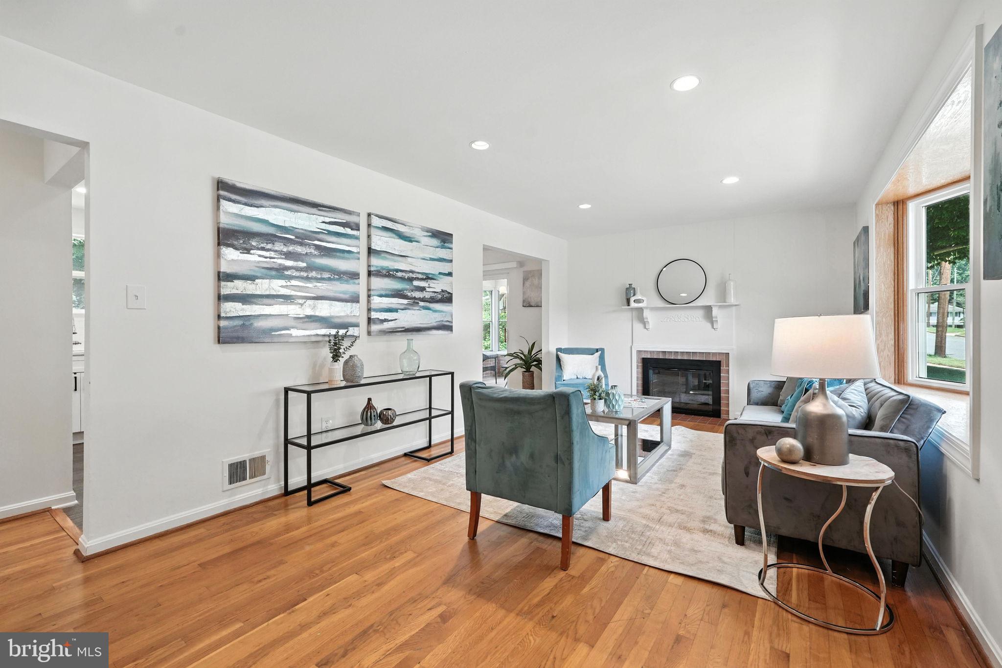 6910 Barnack Drive Springfield, VA 22152 - Photo 7 of 44 a living room with furniture a window and a fireplace