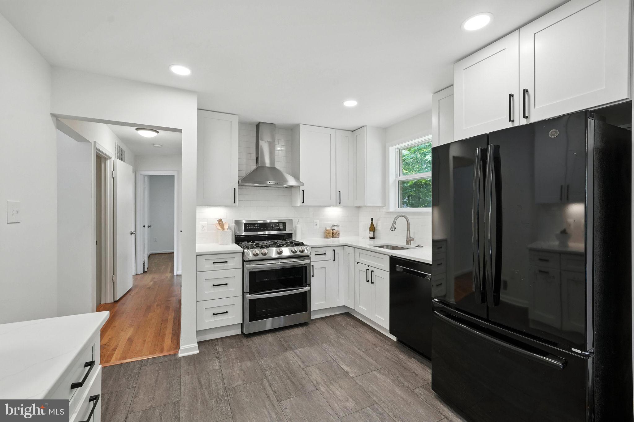 6910 Barnack Drive Springfield, VA 22152 - Photo 10 of 44 a kitchen with stainless steel appliances a refrigerator stove and sink
