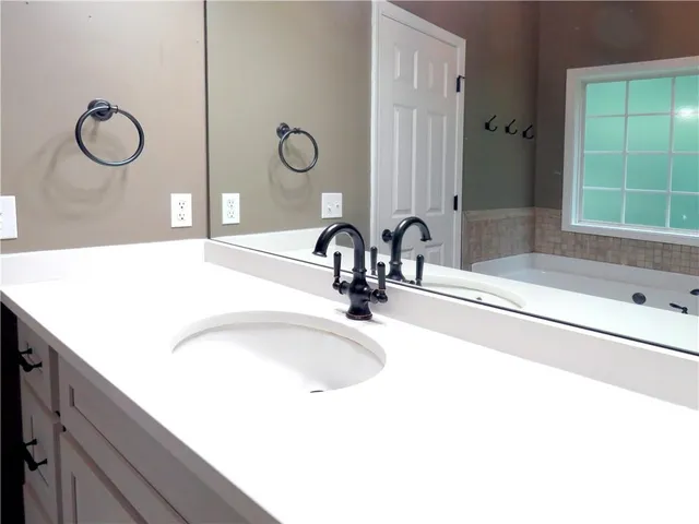 a view of a hallway with wooden floor and closet area