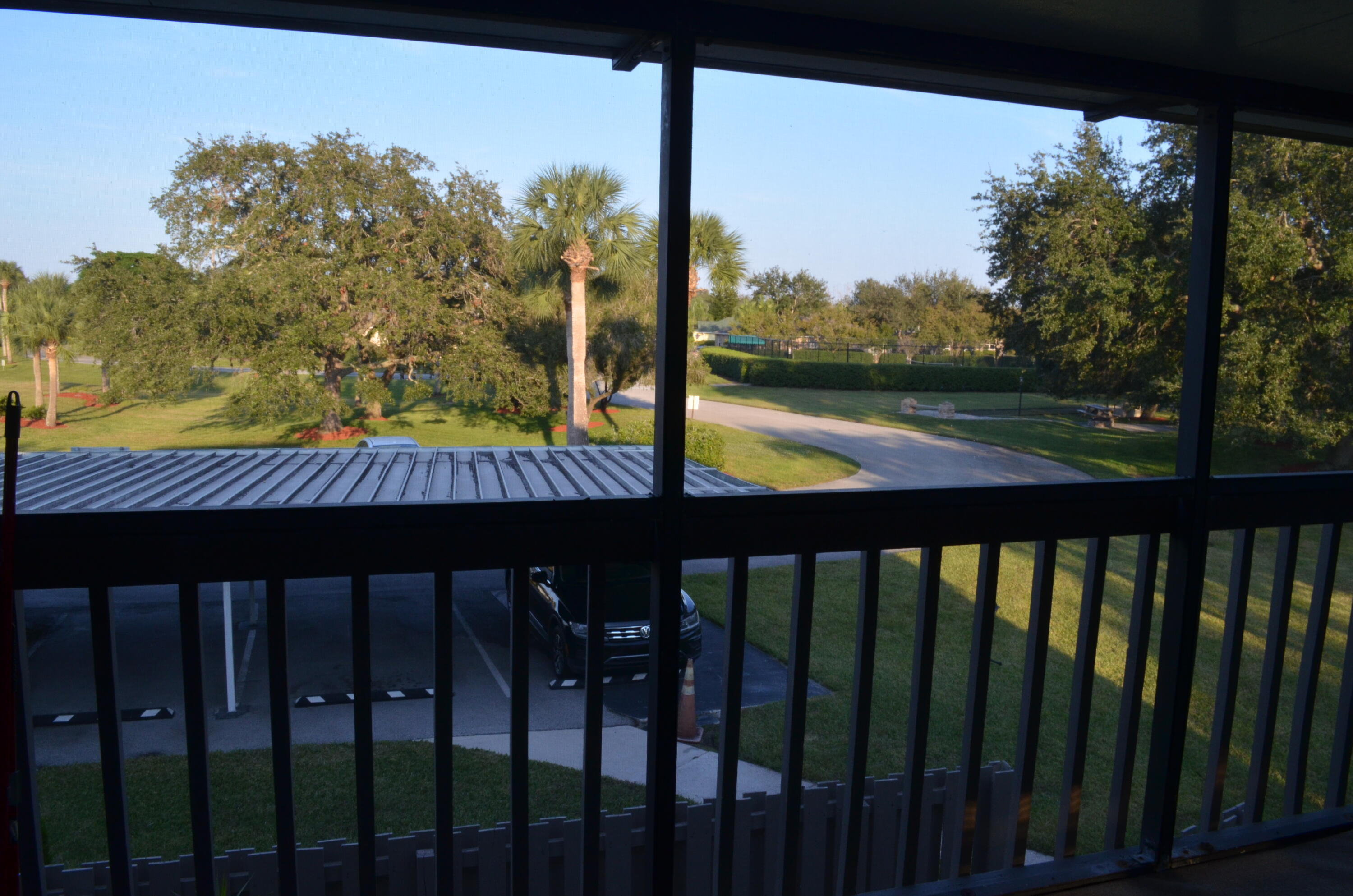 1212 Breezy Way, Unit 7H Sebastian, FL 32958 - Photo 18 of 26 a view of a wooden deck with a garden