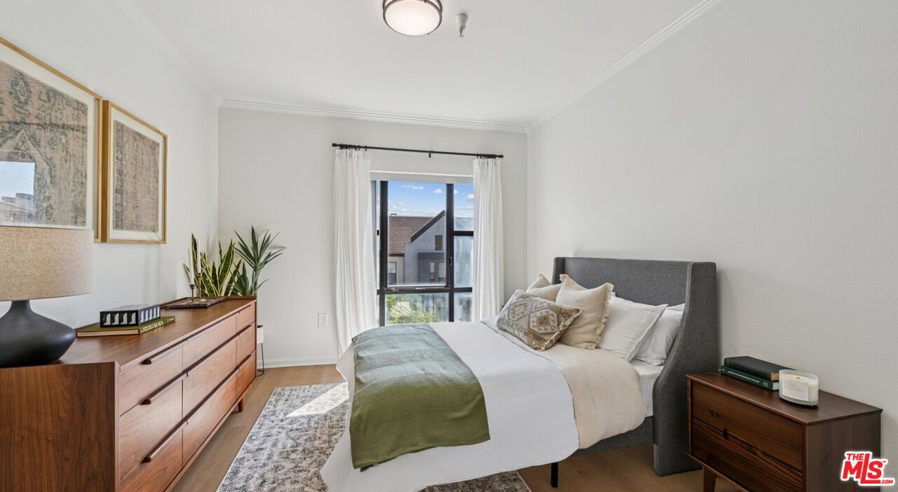 290 North Hudson Avenue, Unit 305W Pasadena, CA 91101 - Photo 16 of 21 a bedroom with a bed and a window