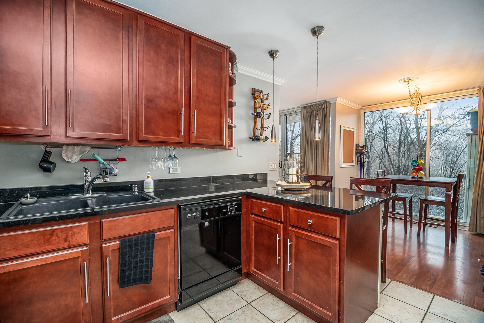 6015 Forest View Road, Unit 1A Lisle, IL 60532 - Photo 12 of 32 a kitchen with kitchen island granite countertop a sink counter top space and cabinets