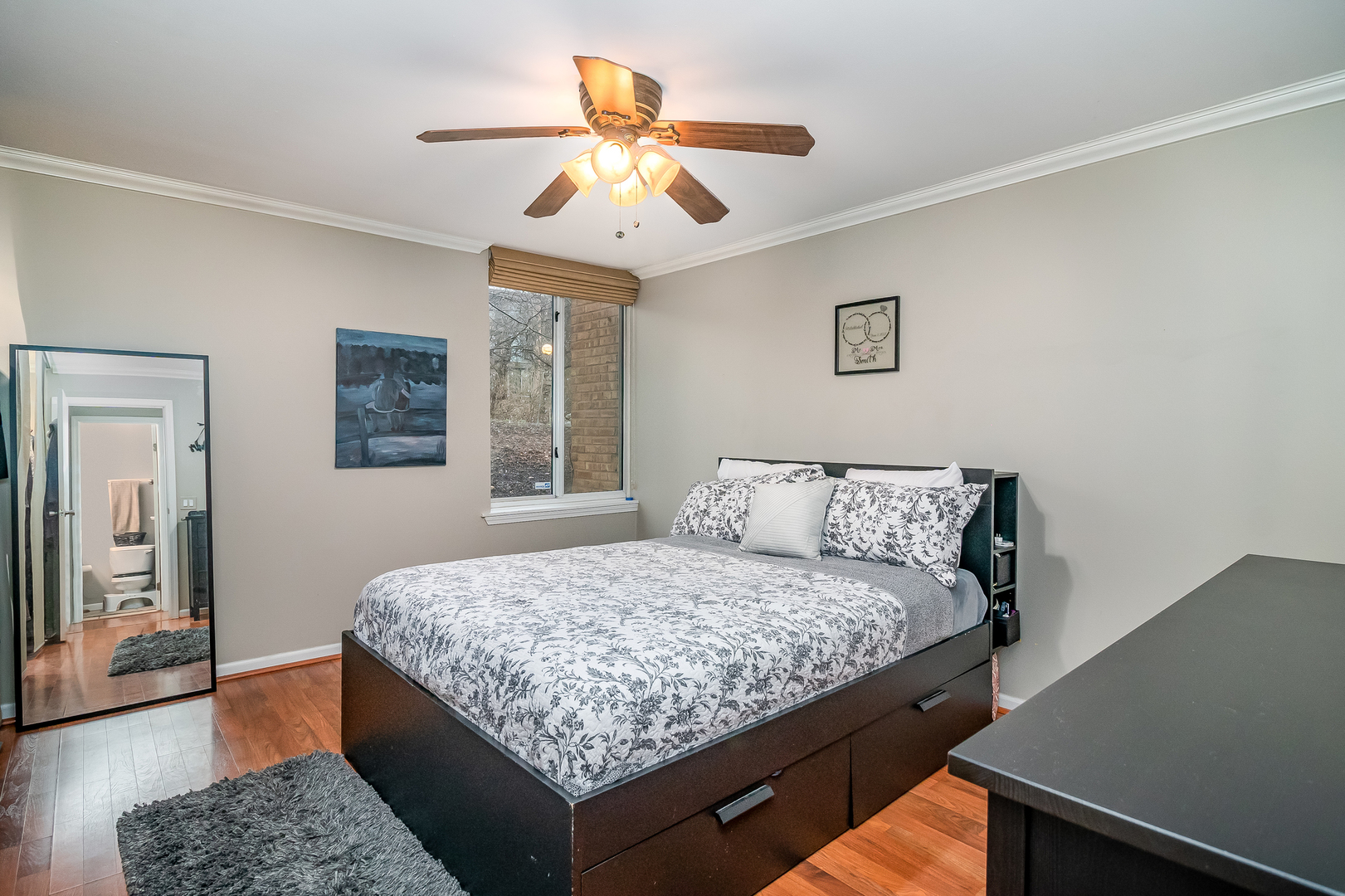 6015 Forest View Road, Unit 1A Lisle, IL 60532 - Photo 13 of 32 a bedroom with a large bed and a chandelier