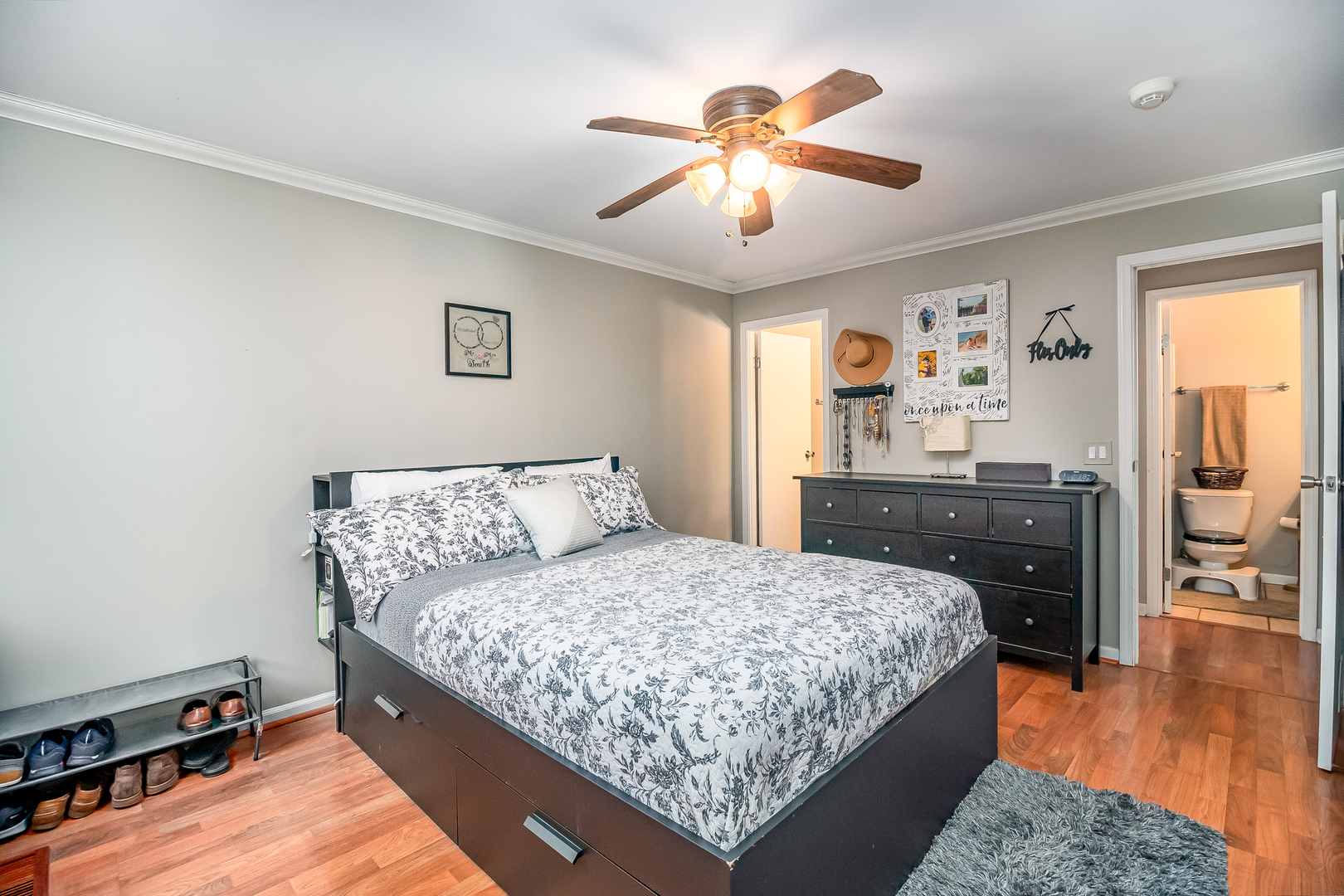 6015 Forest View Road, Unit 1A Lisle, IL 60532 - Photo 14 of 32 a bedroom with a large bed and a chandelier