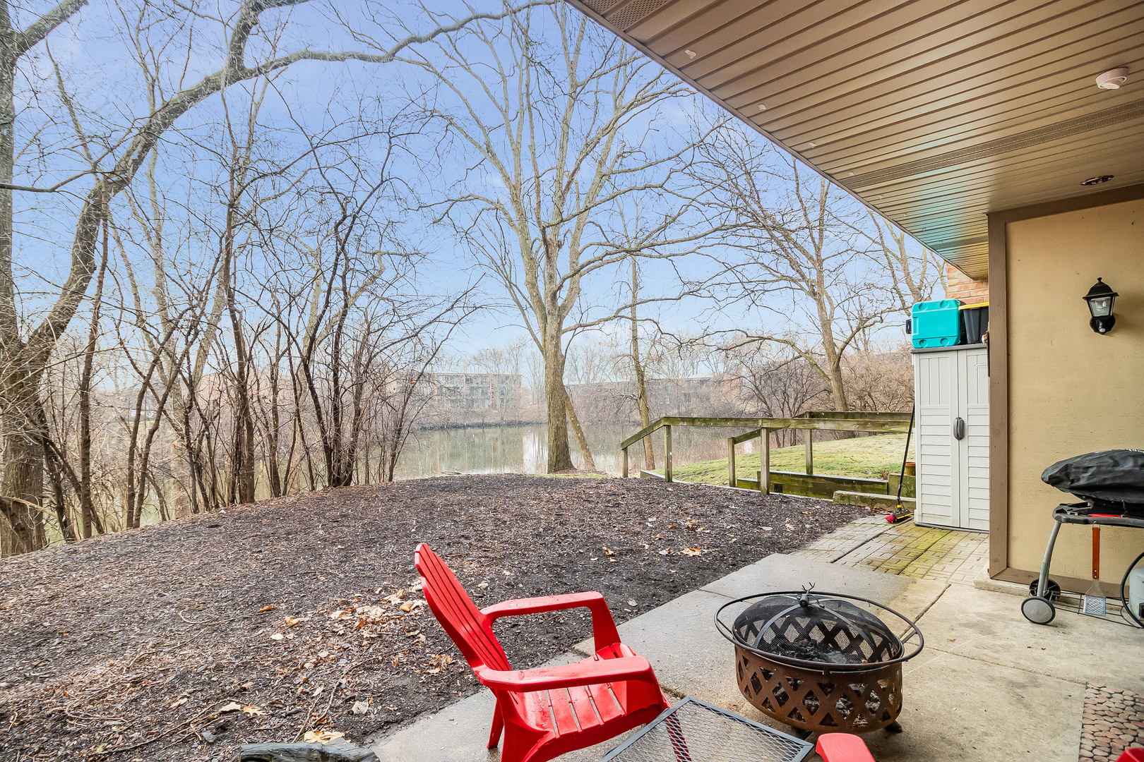 6015 Forest View Road, Unit 1A Lisle, IL 60532 - Photo 20 of 32 a backyard of a house with barbeque oven table and chairs