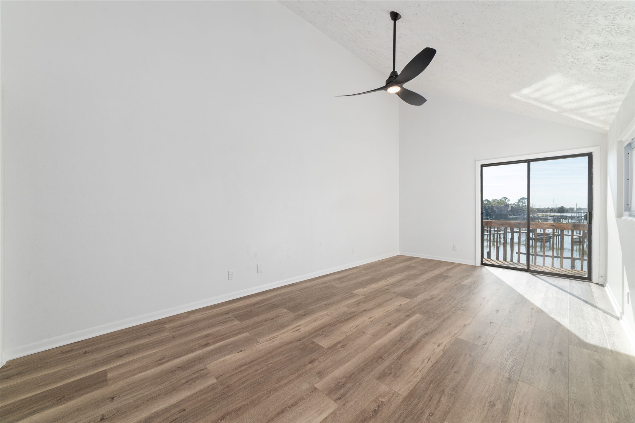 717 Davis Road League City, TX 77573 - Photo 21 of 32 a view of an empty room with a window and wooden floor