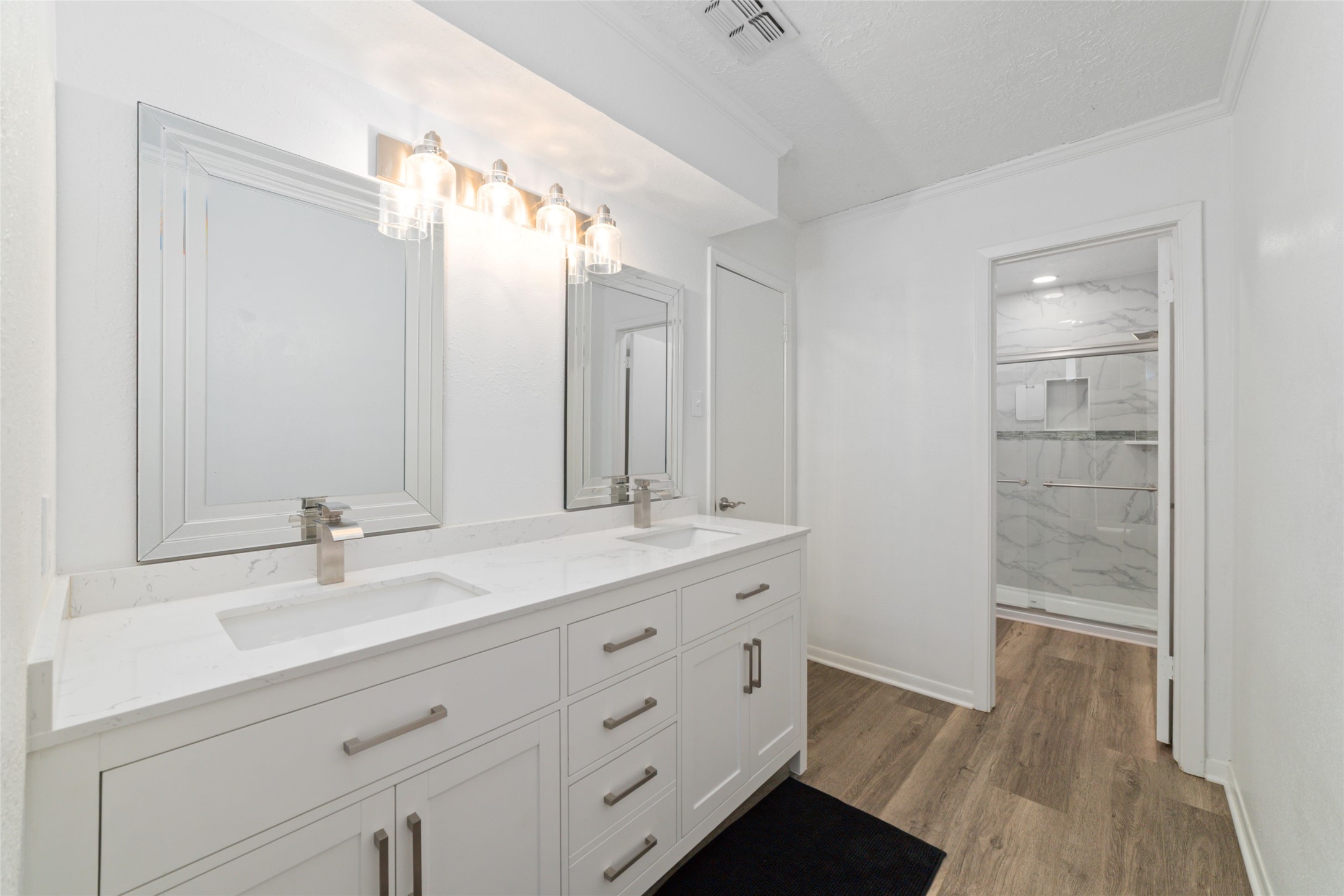 717 Davis Road League City, TX 77573 - Photo 23 of 32 a bathroom with a double vanity sink and mirror