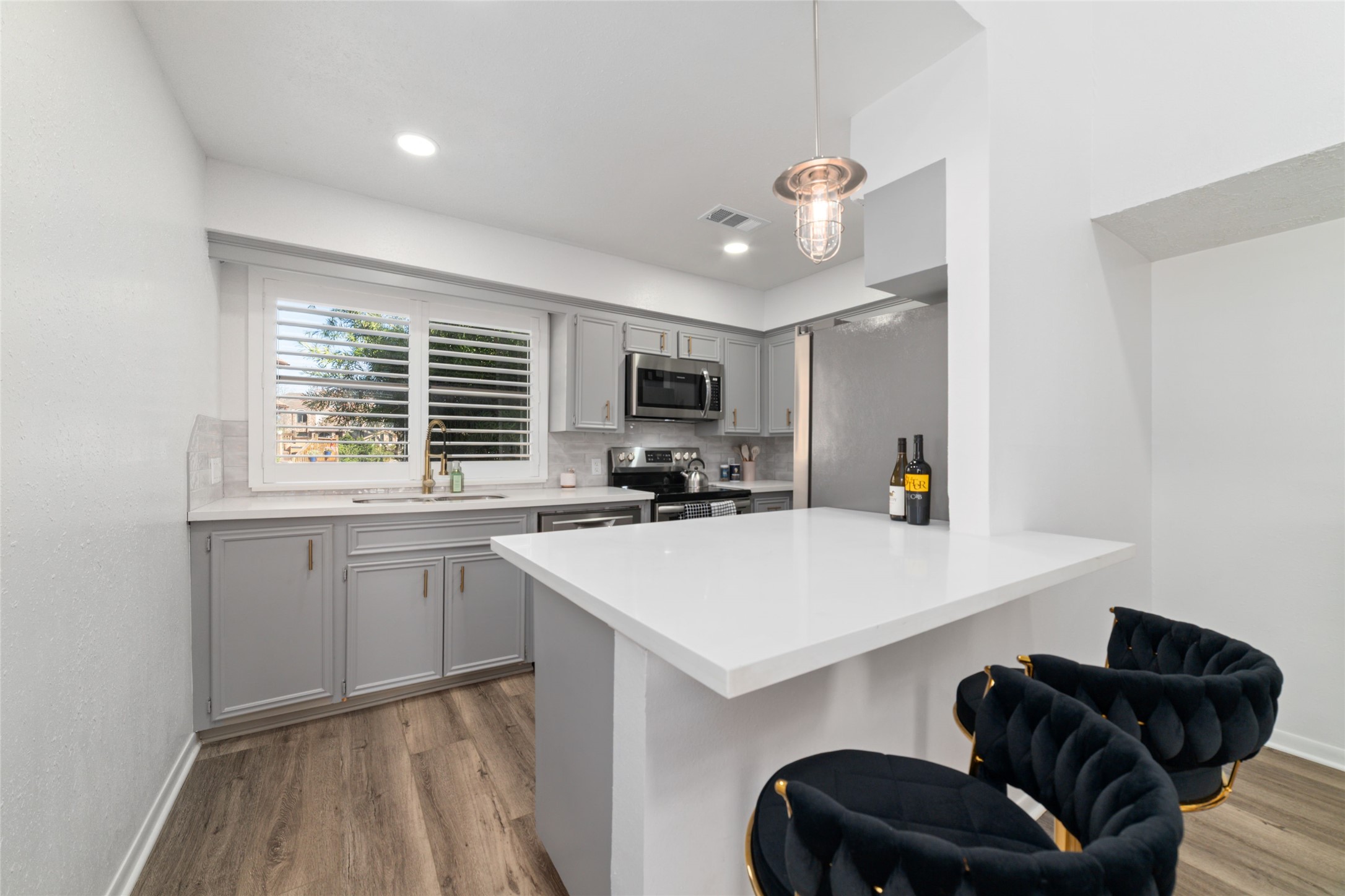 717 Davis Road League City, TX 77573 - Photo 6 of 32 a kitchen with a sink a stove a microwave a refrigerator a washer and dryer