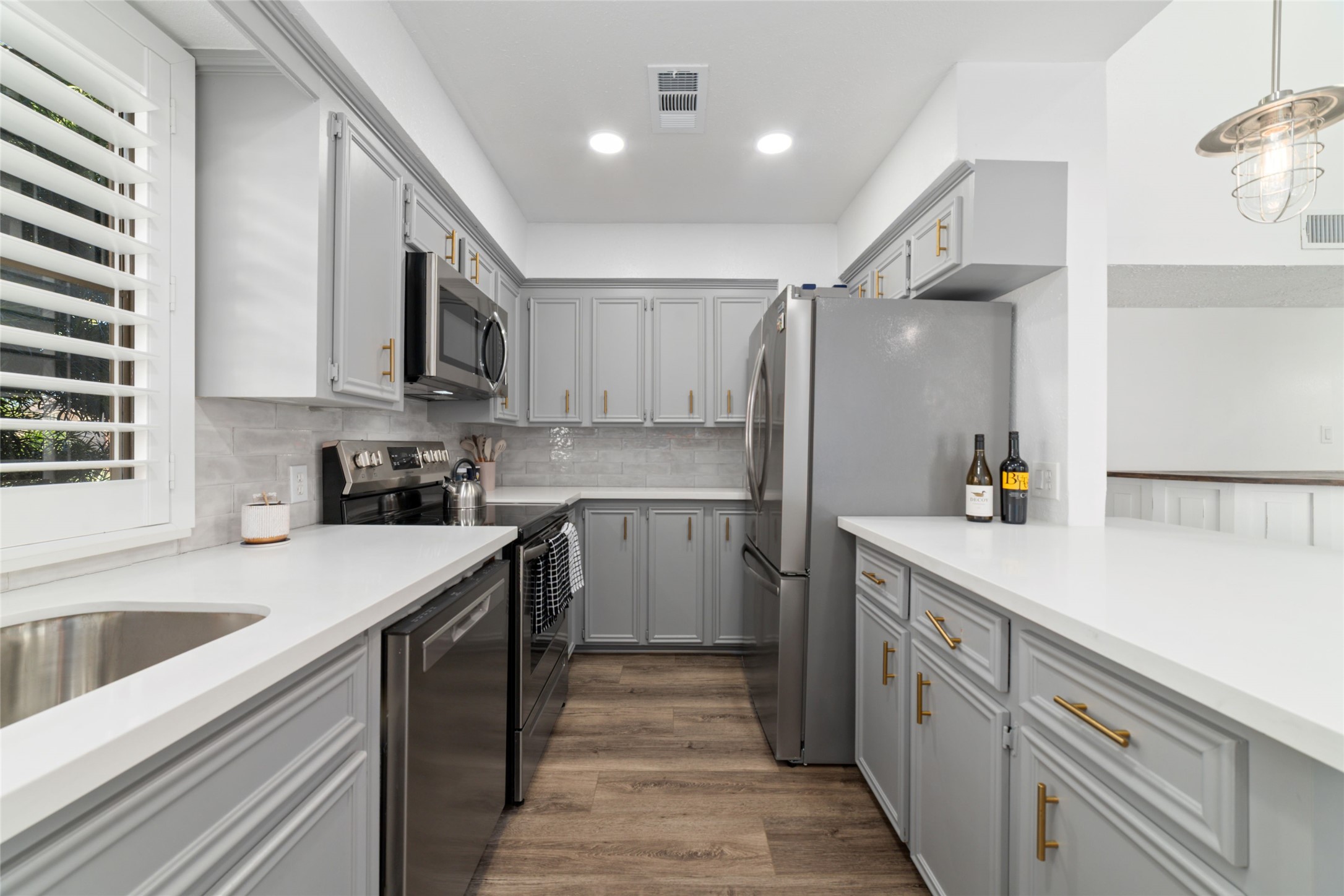 717 Davis Road League City, TX 77573 - Photo 8 of 32 a kitchen with kitchen island granite countertop a sink appliances cabinets and counter space