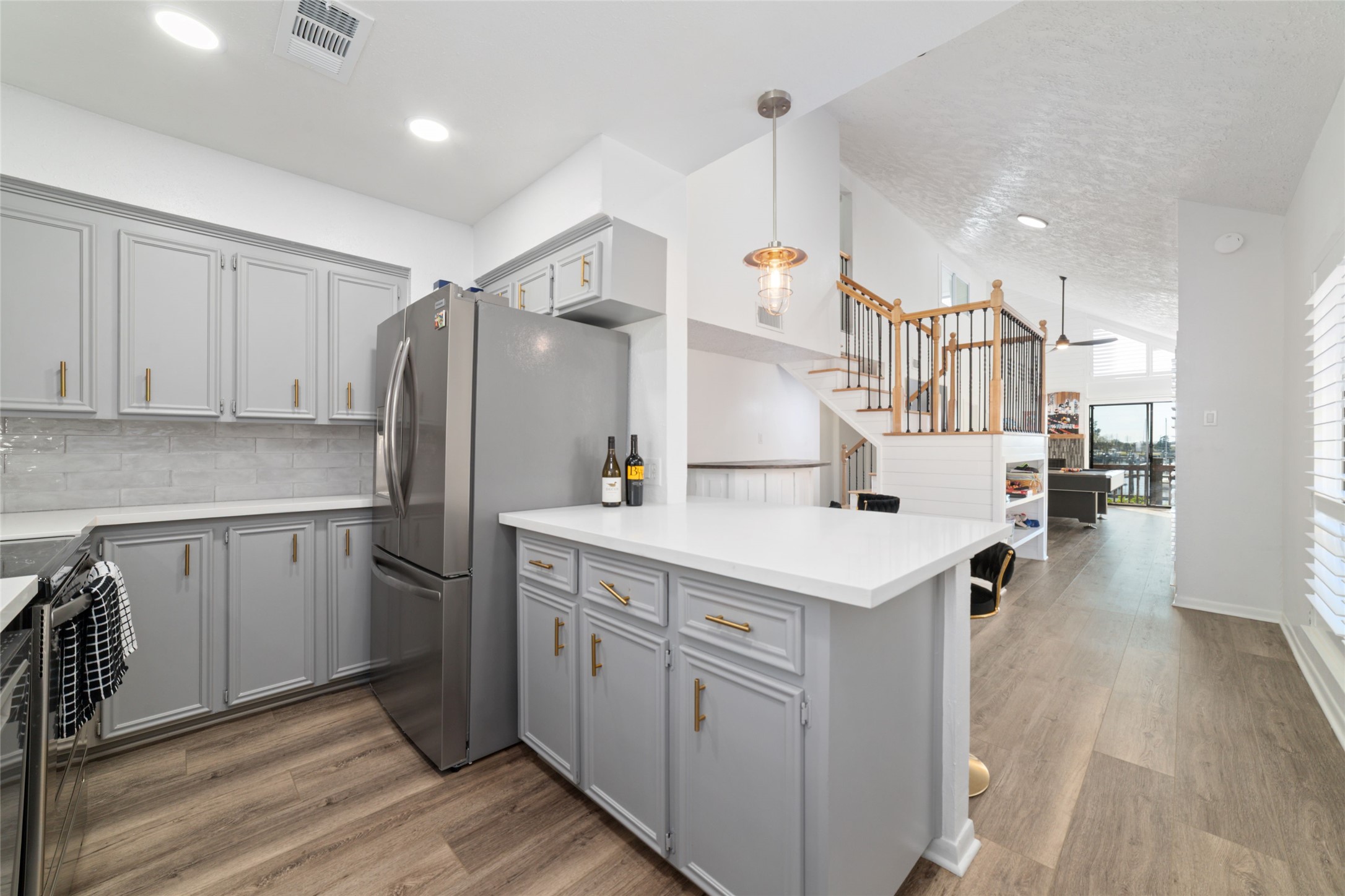 717 Davis Road League City, TX 77573 - Photo 9 of 32 a kitchen with a sink a refrigerator and white cabinets