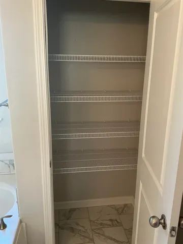 a kitchen with granite countertop a sink a stove a microwave and cabinets