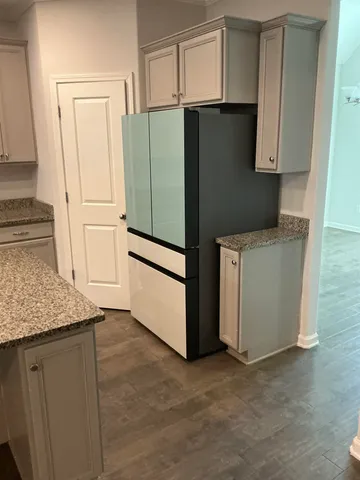 a kitchen with granite countertop a sink and cabinets