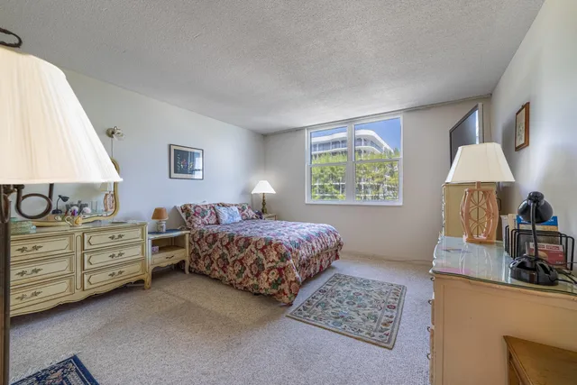 a bedroom with a bed and a dresser in it