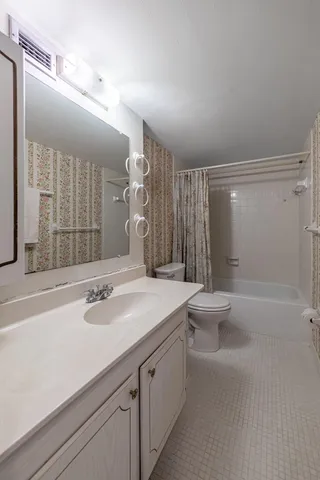 a bathroom with a sink a large mirror and a shower