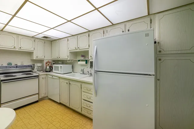 a white refrigerator freezer sitting inside of a kitchen
