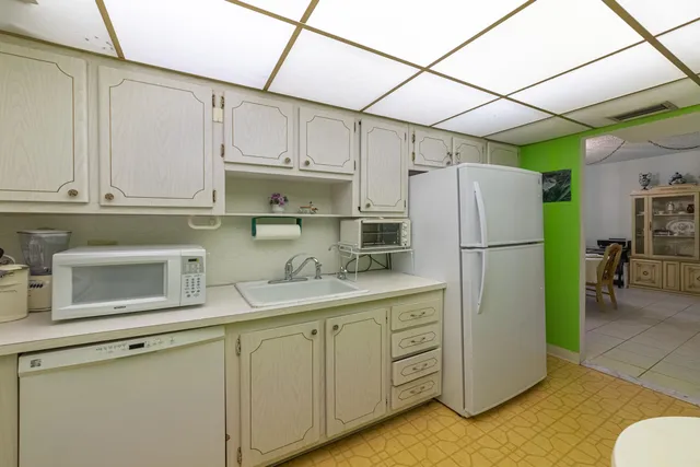 a kitchen with refrigerator and cabinets