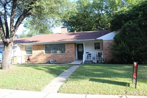 a view of a house with a yard and tree s
