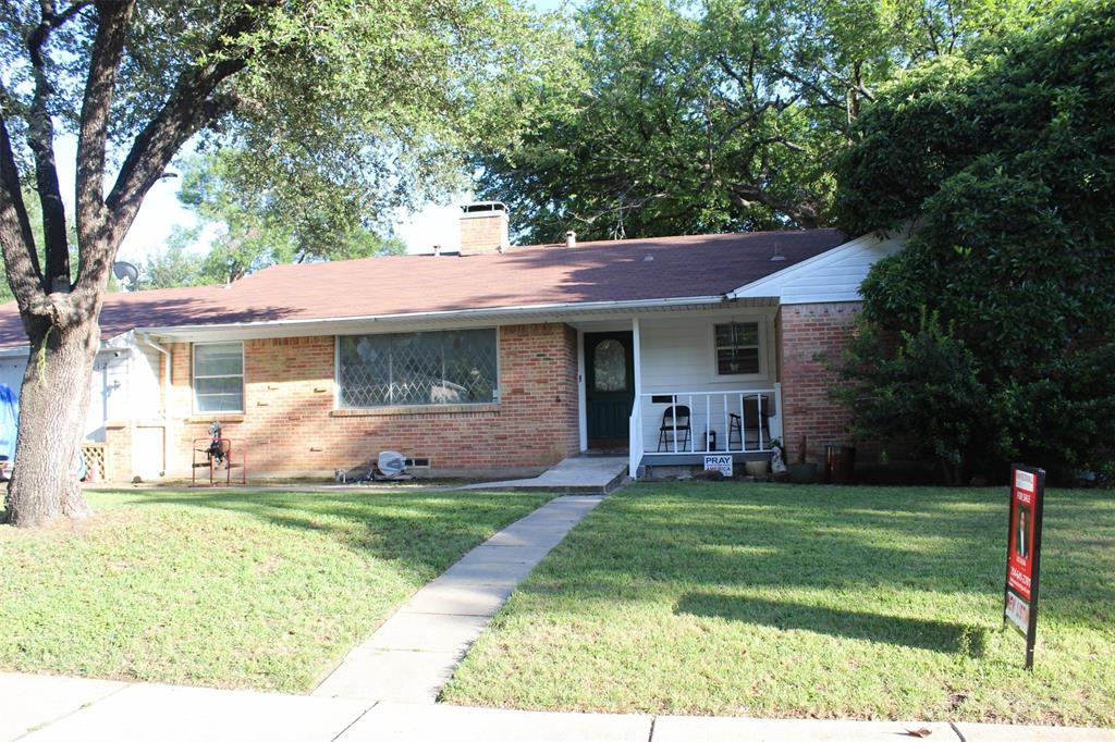 a view of a house with a yard and tree s