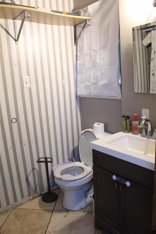 612 Ranier Circle Garland, TX 75041 - Photo 12 of 29 a bathroom with a sink a toilet and shower curtain