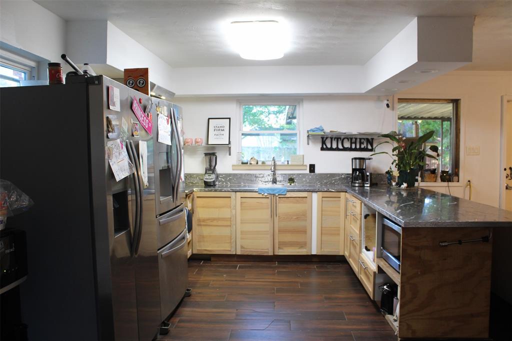 612 Ranier Circle Garland, TX 75041 - Photo 18 of 29 a kitchen with stainless steel appliances granite countertop a refrigerator a stove a sink and a window