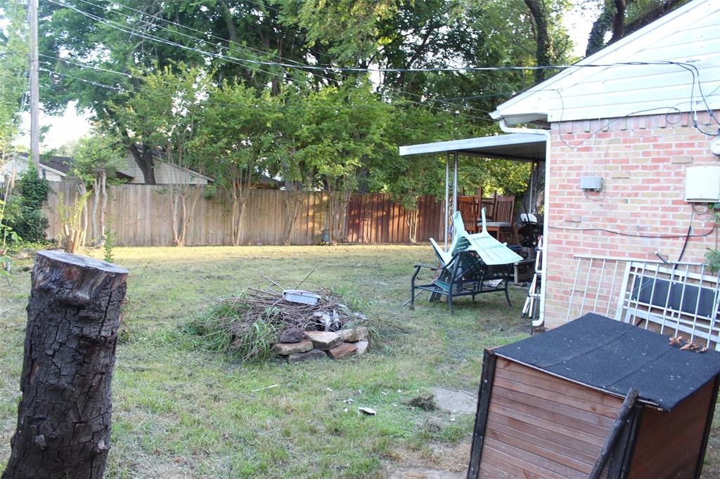612 Ranier Circle Garland, TX 75041 - Photo 29 of 29 a view of a backyard with chairs and a table