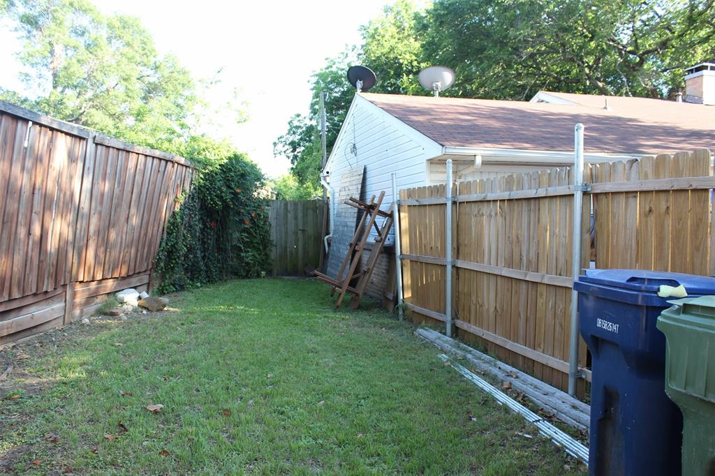 612 Ranier Circle Garland, TX 75041 - Photo 4 of 29 a view of a backyard with a wooden fence