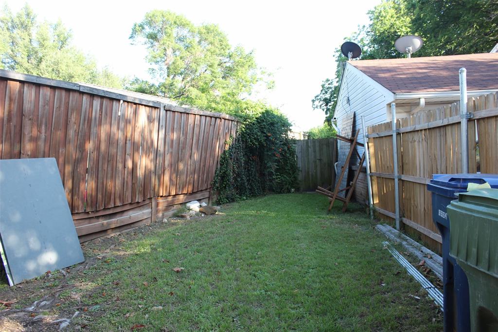 612 Ranier Circle Garland, TX 75041 - Photo 5 of 29 a backyard with wooden fence and a bench