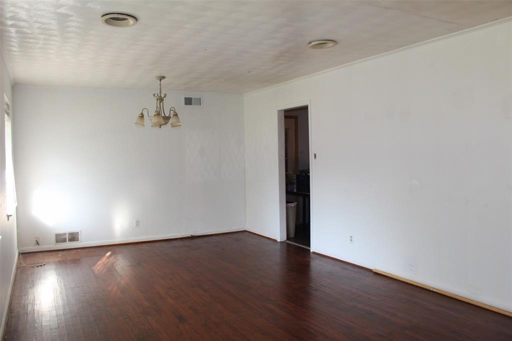 612 Ranier Circle Garland, TX 75041 - Photo 9 of 29 an empty room with wooden floor and windows