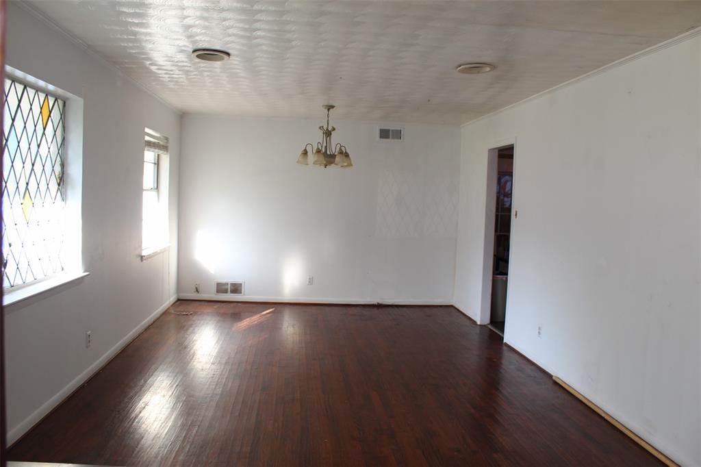612 Ranier Circle Garland, TX 75041 - Photo 10 of 29 an empty room with wooden floor and windows