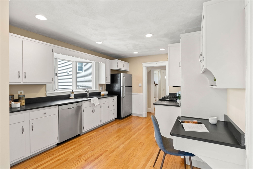 156 Russett Road Boston, MA 02132 - Photo 14 of 32 a kitchen with white cabinets and sink