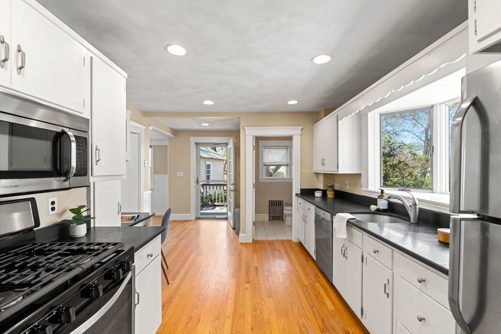 156 Russett Road Boston, MA 02132 - Photo 15 of 32 a kitchen with stainless steel appliances a stove sink and microwave