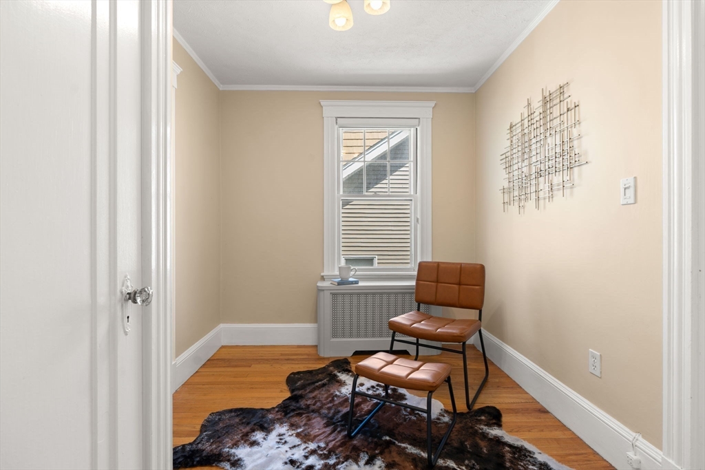 156 Russett Road Boston, MA 02132 - Photo 20 of 32 a bedroom with a bed and wooden floor