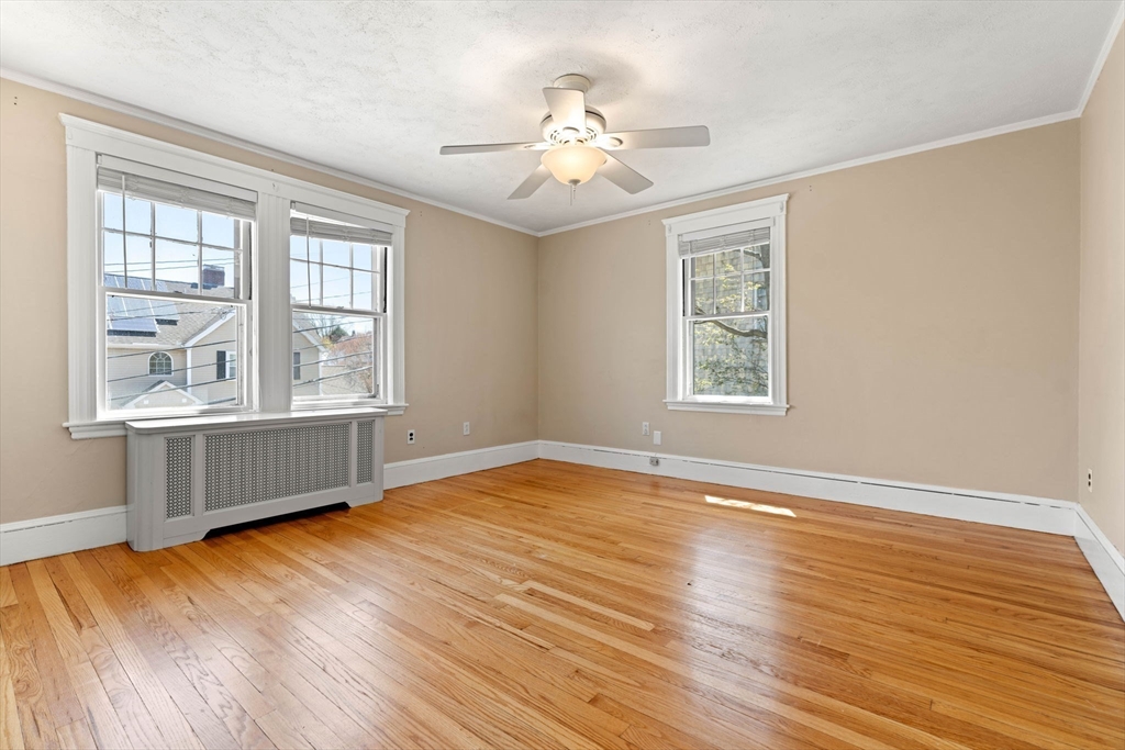 156 Russett Road Boston, MA 02132 - Photo 22 of 32 a view of an empty room with wooden floor and a window