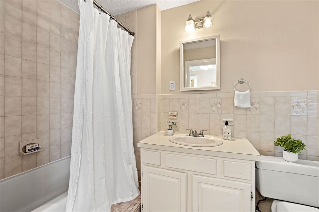 156 Russett Road Boston, MA 02132 - Photo 23 of 32 a bathroom with a sink toilet and shower