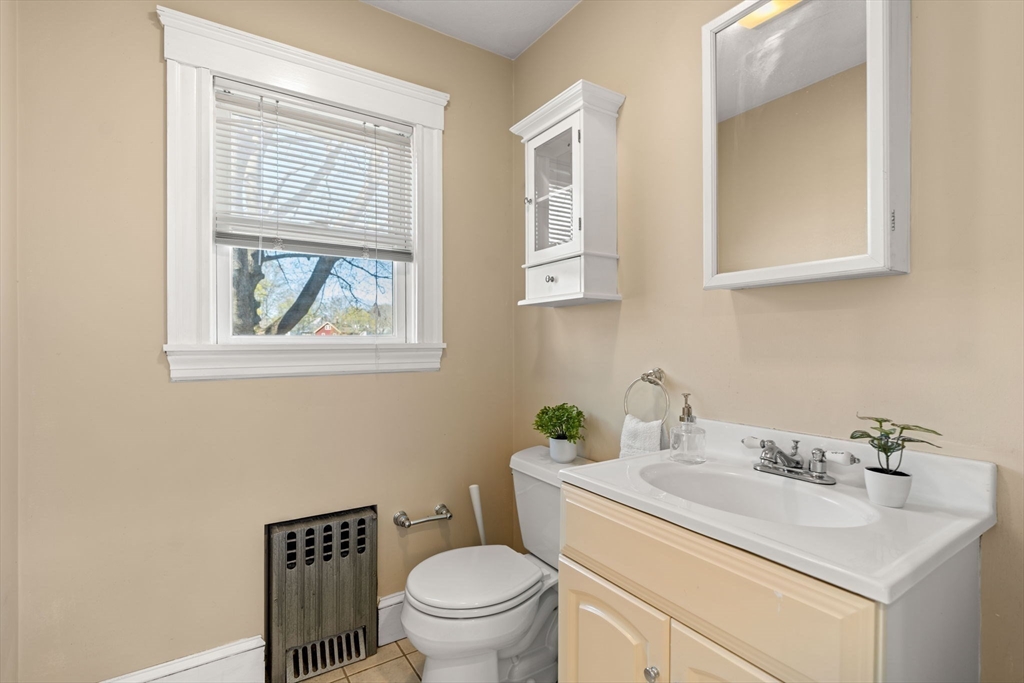 156 Russett Road Boston, MA 02132 - Photo 24 of 32 a bathroom with a toilet sink vanity and mirror