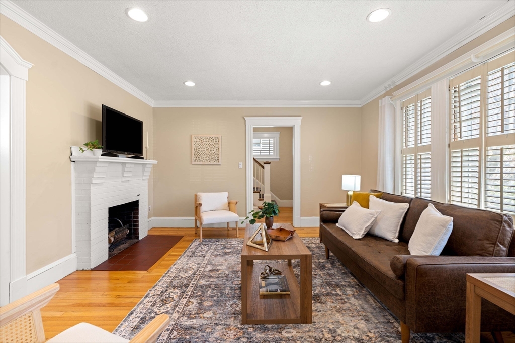 156 Russett Road Boston, MA 02132 - Photo 5 of 32 a living room with furniture a flat screen tv and a fireplace