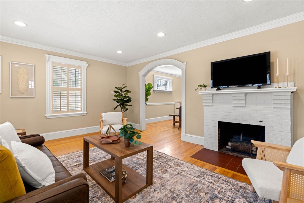 156 Russett Road Boston, MA 02132 - Photo 7 of 32 a living room with furniture a flat screen tv and a fireplace