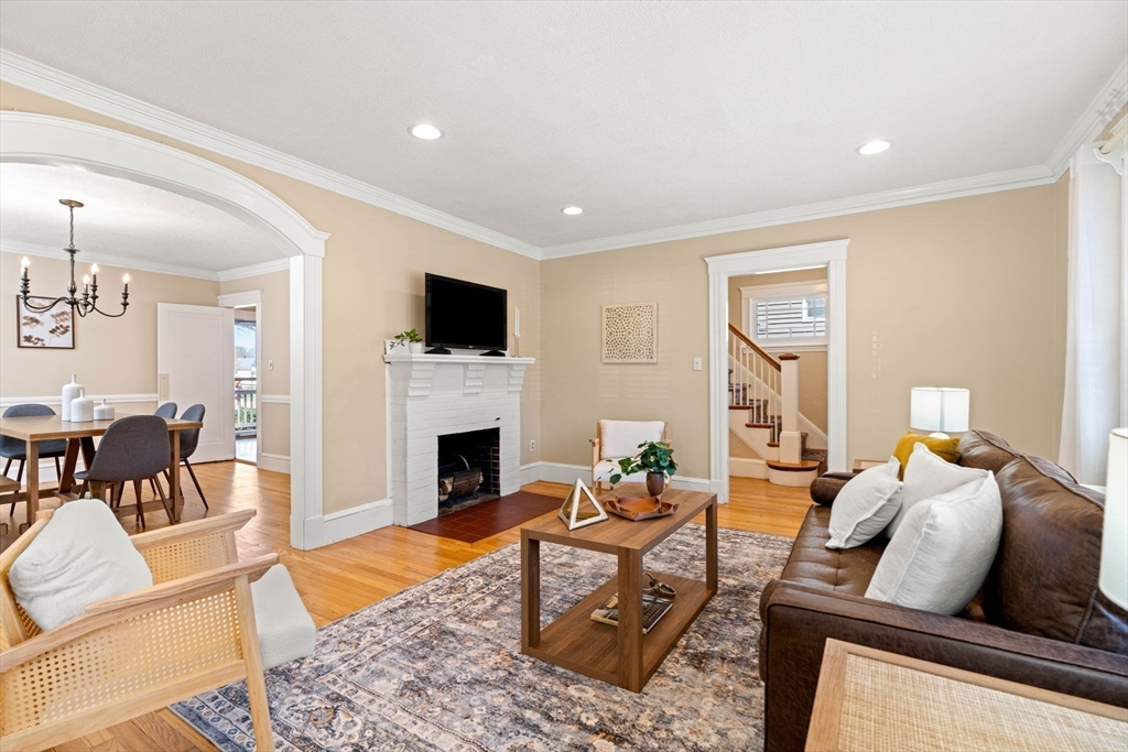 156 Russett Road Boston, MA 02132 - Photo 8 of 32 a living room with furniture a fireplace and a flat screen tv